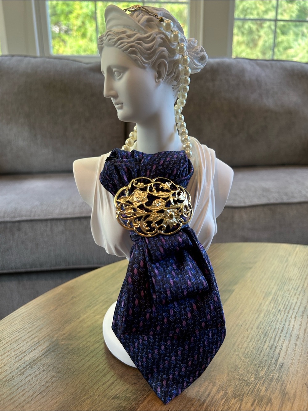 Statement tie-style pearl necklace with gold-tone brooch